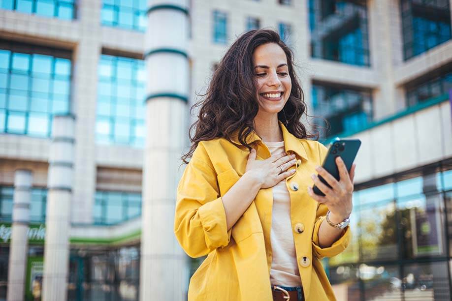 Happy lady holding mobile phone